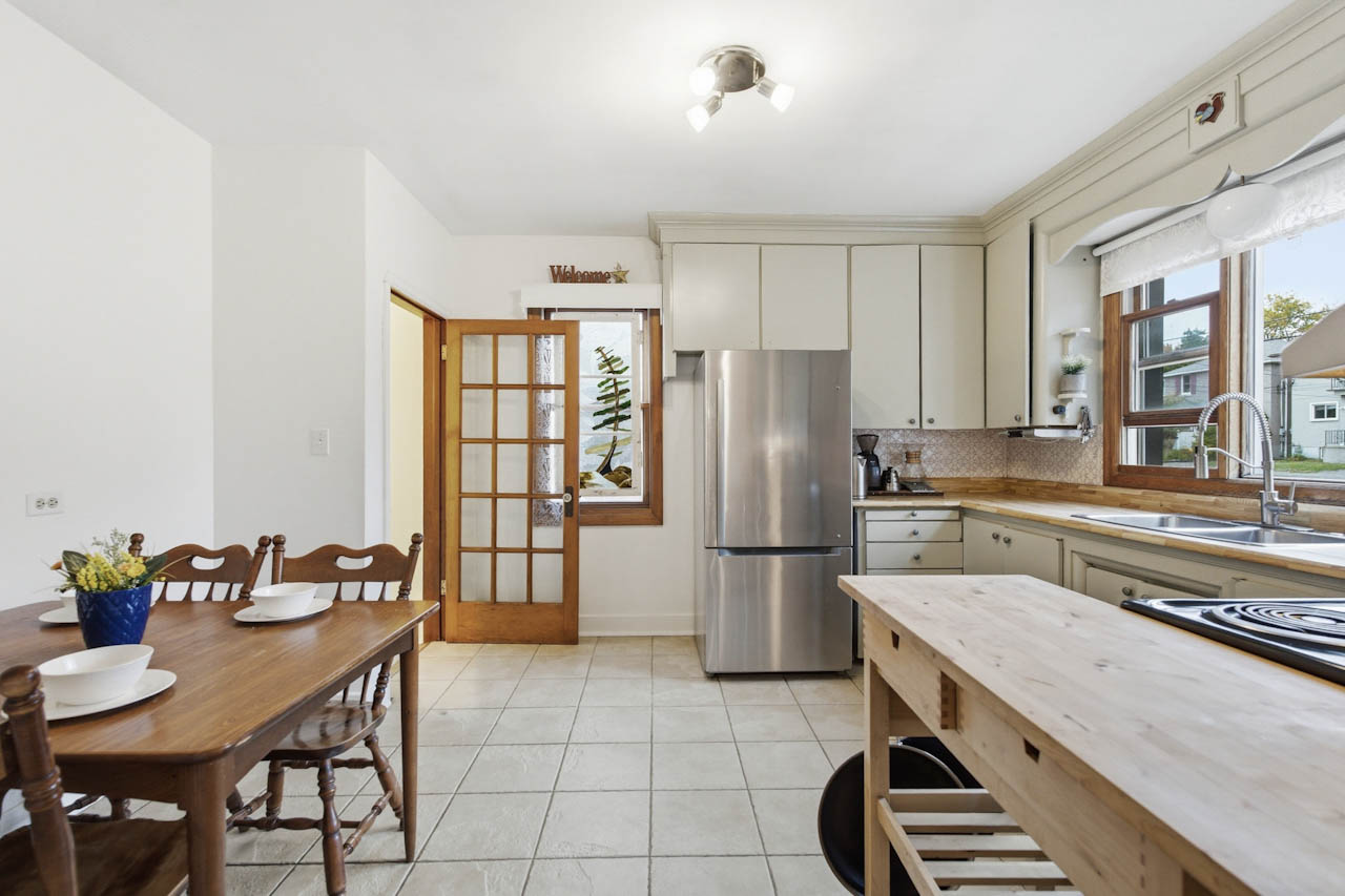 Kitchen and dining area with glass-panel French door and wood dining table